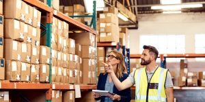 Health and safety inspection with some people in a warehouse.